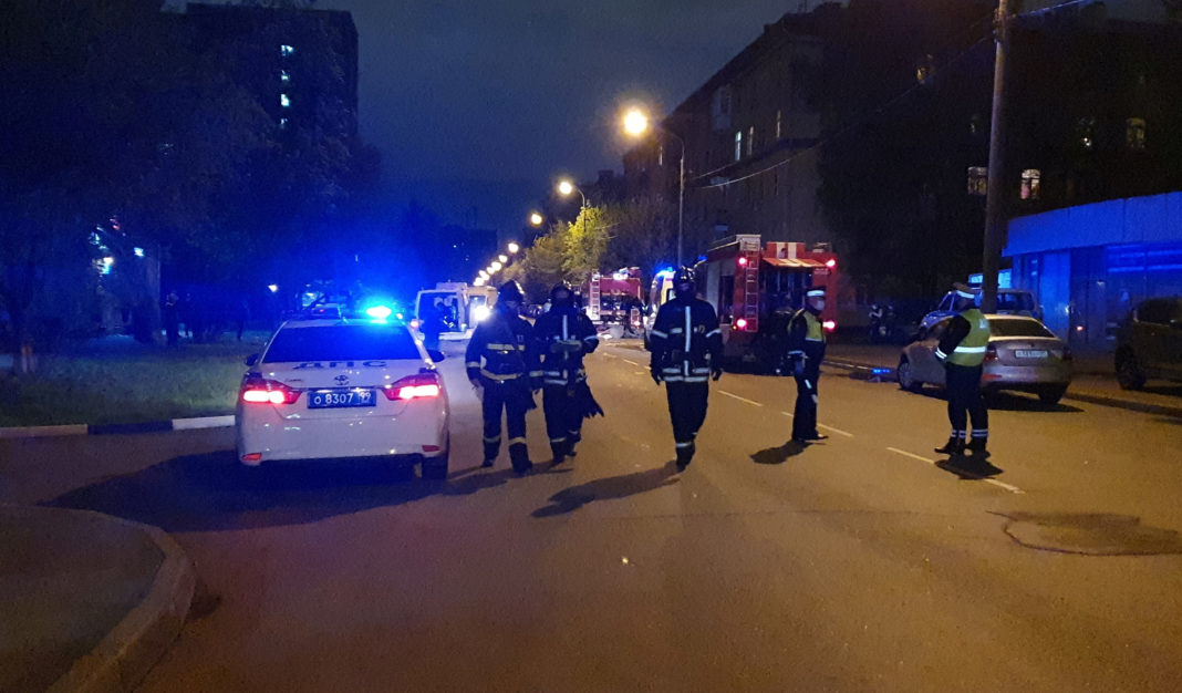Firefighters and traffic police officers are seen near the scene of an accident, after fire broke out at a hospital treating patients infected with the coronavirus disease in Moscow